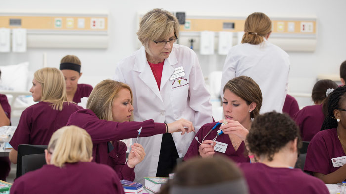 Students collaborate in a lab course in the school of nursing.