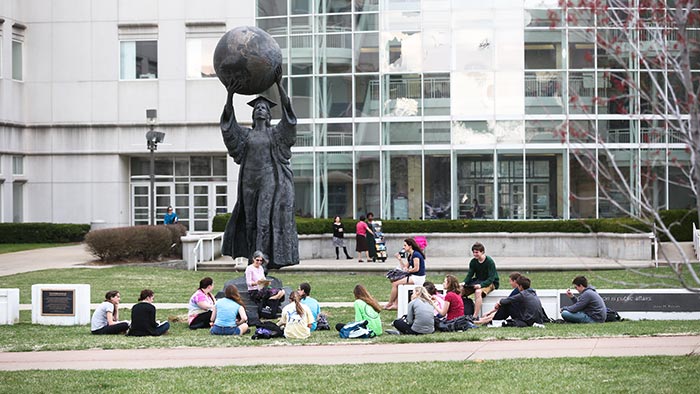 Students having class by the Citizen Scholar statue