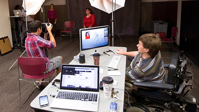 Jackie Newman working with photo services to photograph faculty and staff