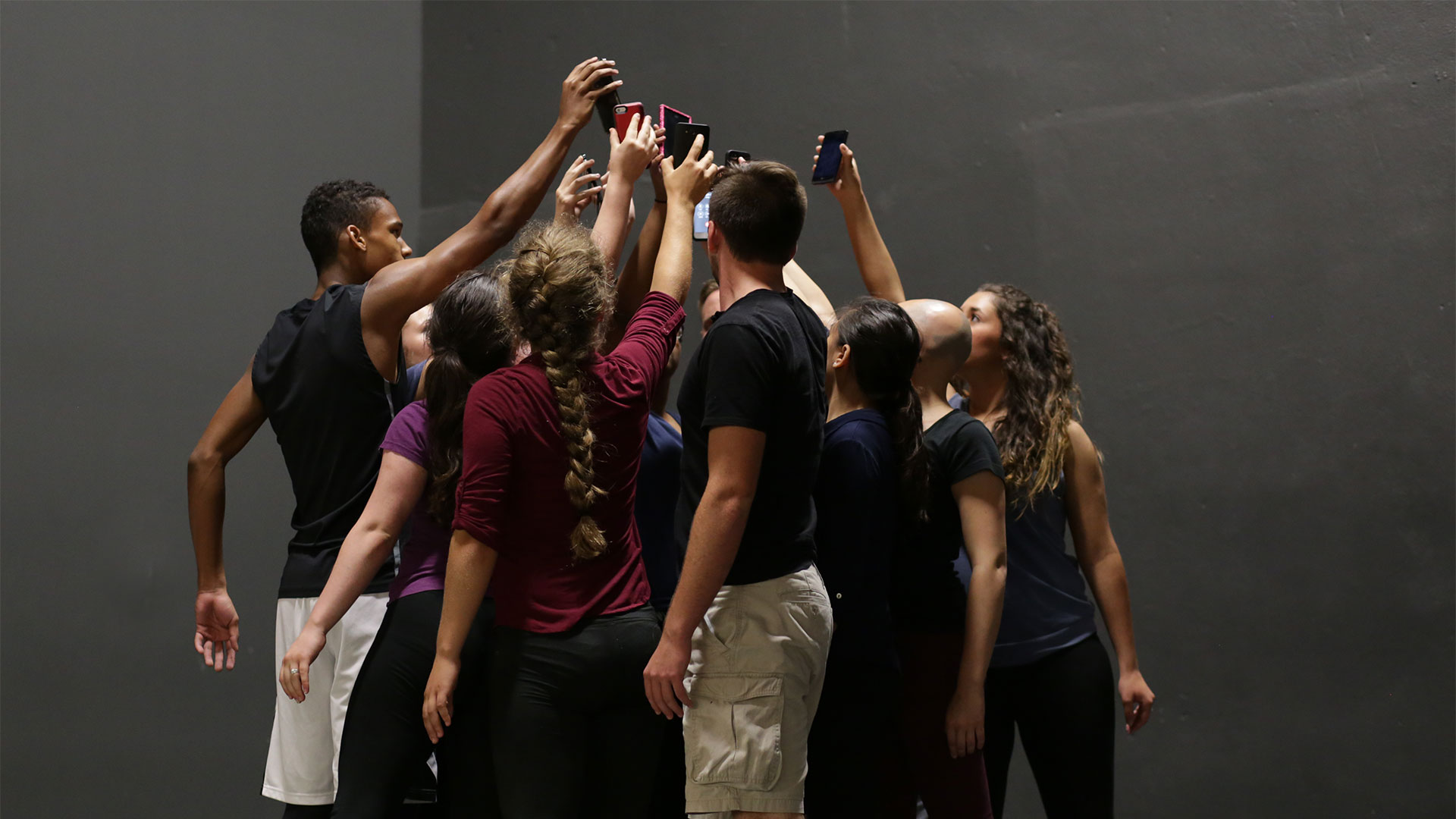 MSU MFAA students huddled with smart phones for group art presentation