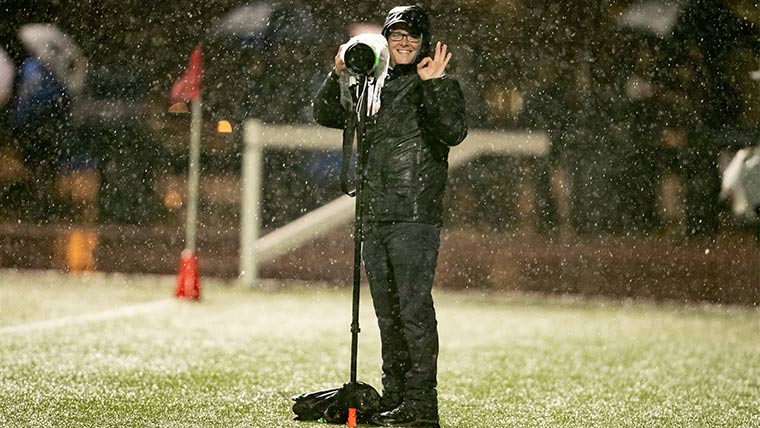 Staff photographer working in the rain.