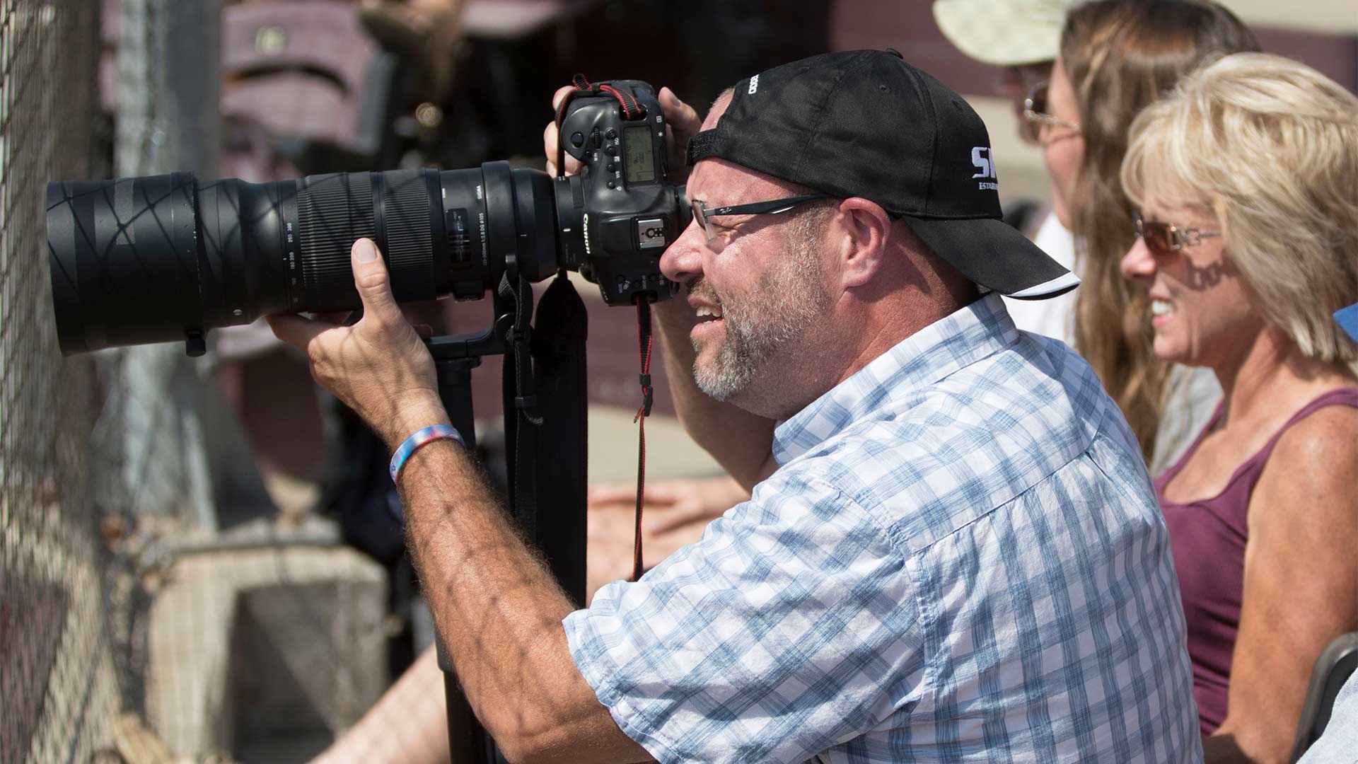 A staff photographer taking photos at a campus event.