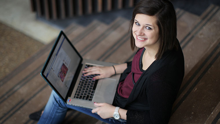 A student scrolling through social media on her laptop