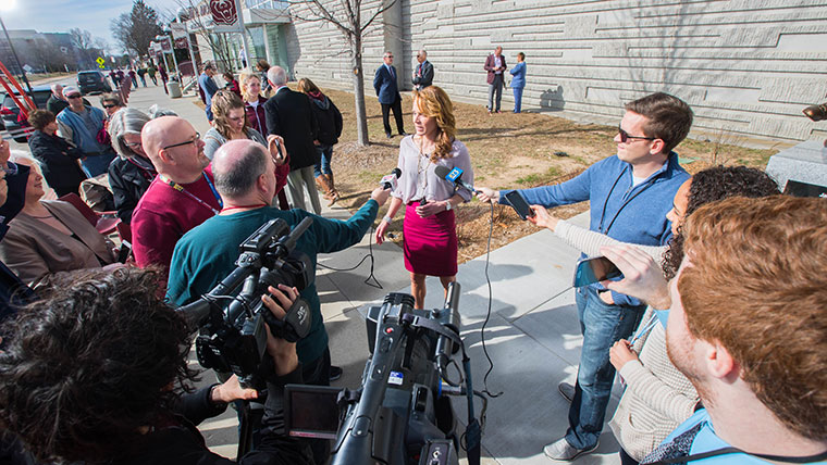 Jackie Stiles, an acclaimed basketball coach and MSU alum, responds to reporters' questions during the unveiling of her statue outside of Great Southern Bank Arena.