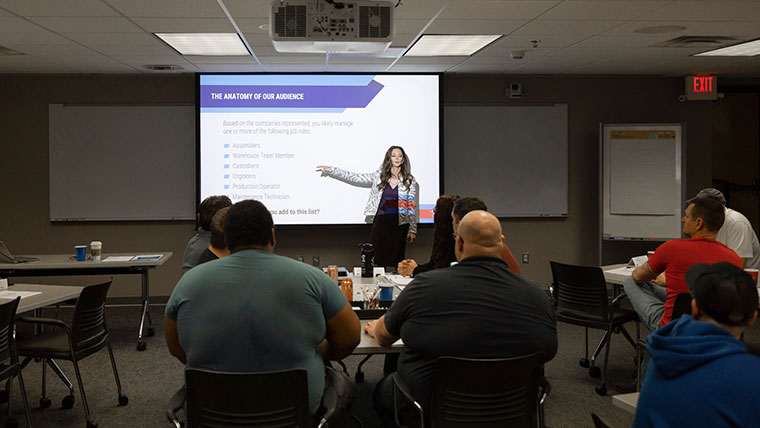 An MSU alumna, Julie Cummings, gives a presentation to a group of individuals at the Small Business Development Center in the eFactory.