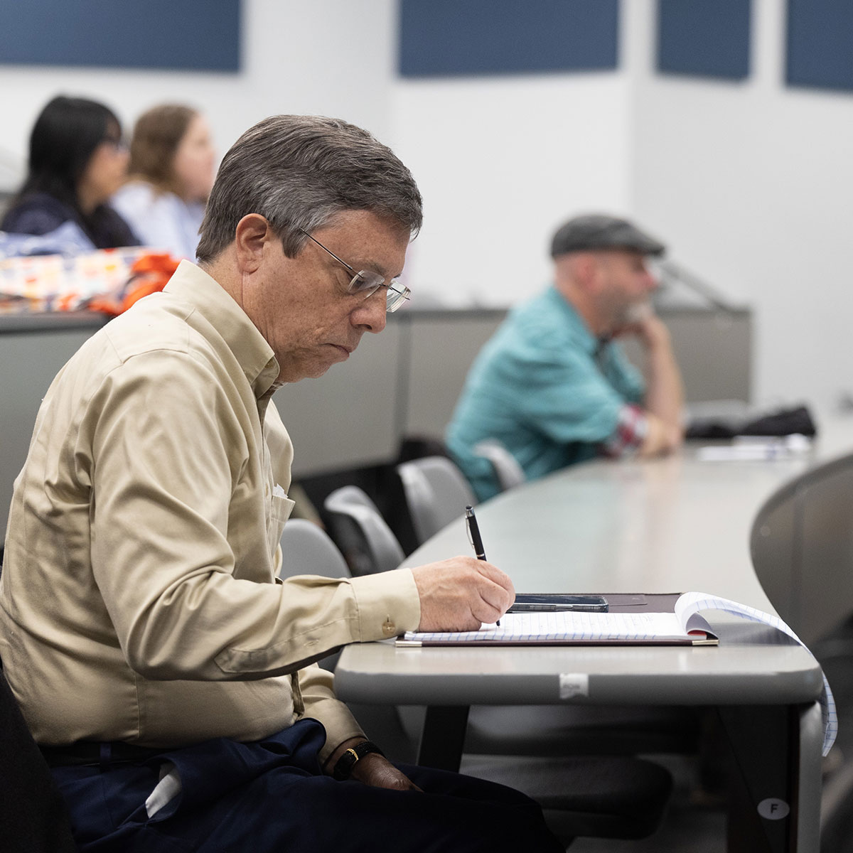 Chuck Busby, an Internet analyst at Missouri State, takes notes during a Marcom Training Week presentation.