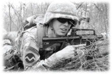 A black-and-white photo of a soldier in the brush