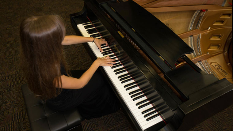 Student playing the piano