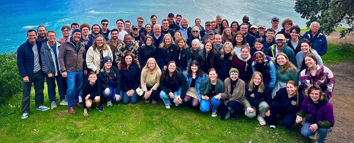 Chamber Choir posing in front of a cove during their trip to South Africa.