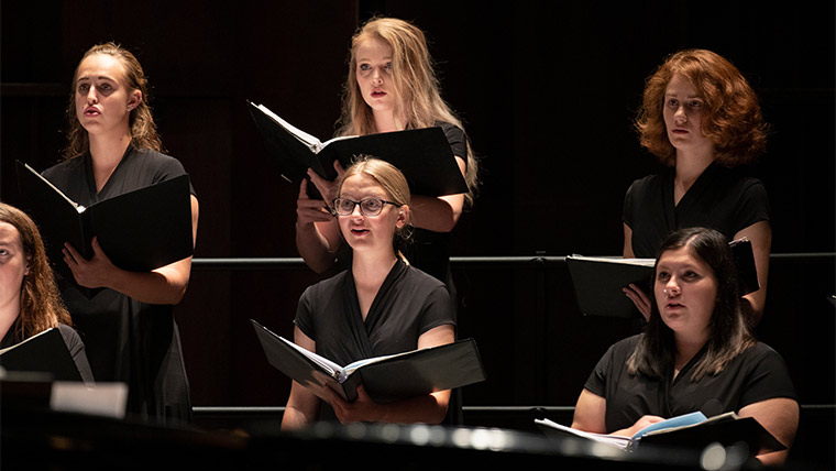 Collegiate Singers performing in a concert.