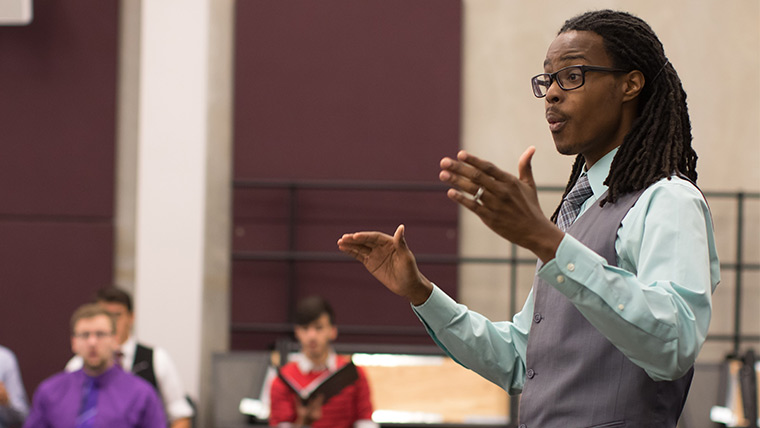 A graduate student conductor practices his technique during a class session.