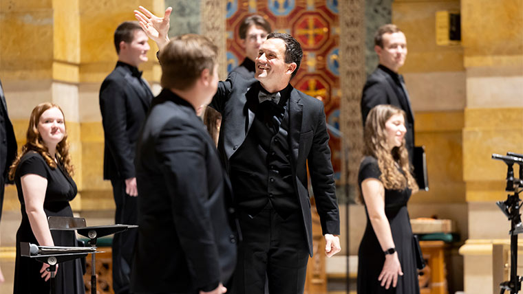 Choral Studies director Dr. Cameron LeBarr and choir receive applause from the audience.