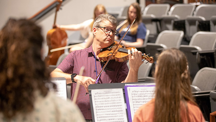 Dr. David Hays plays violin for String Fling students