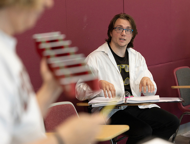 Adult student air plays xylophone
