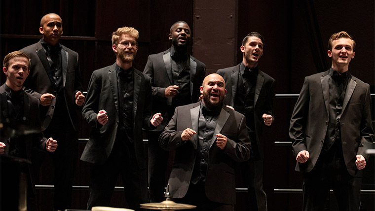 Men's Chorus members performing in a concert.