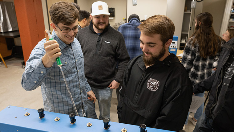 Three Missouri State students together in a lab.