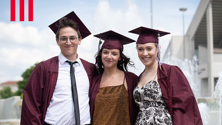 Three Missouri State graduates in cap and gown