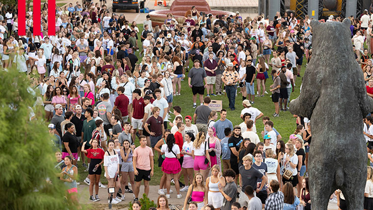 Missouri State students participating in an event in front of the bronze Bear.
