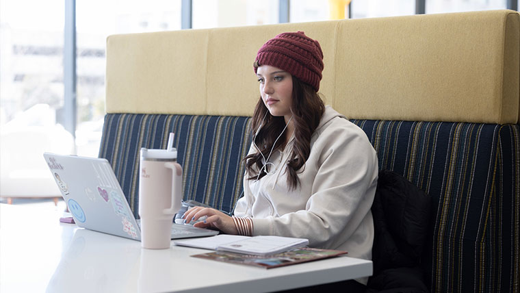 Student sitting at laptop.