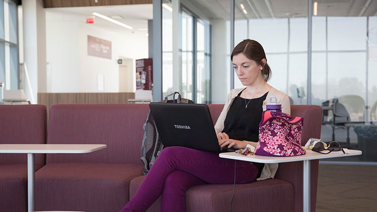 Student studies on her laptop.