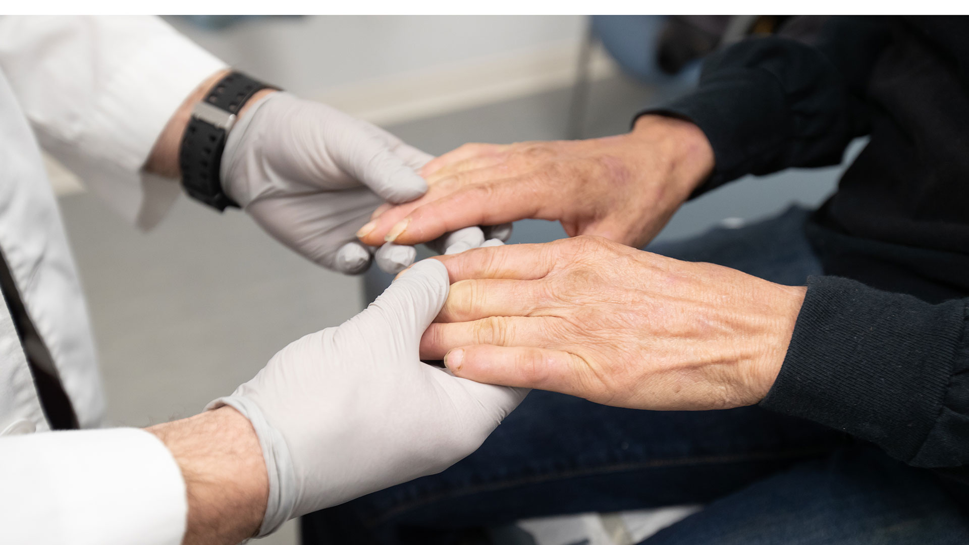 Health care worker holding hands with patient.