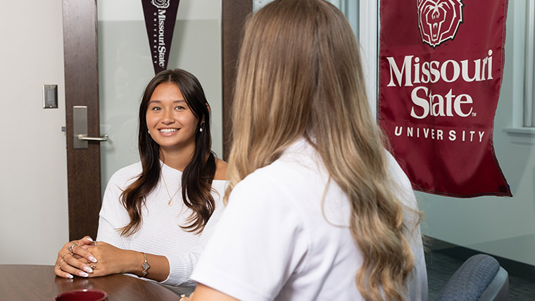 Student chatting with an admissions counselor.