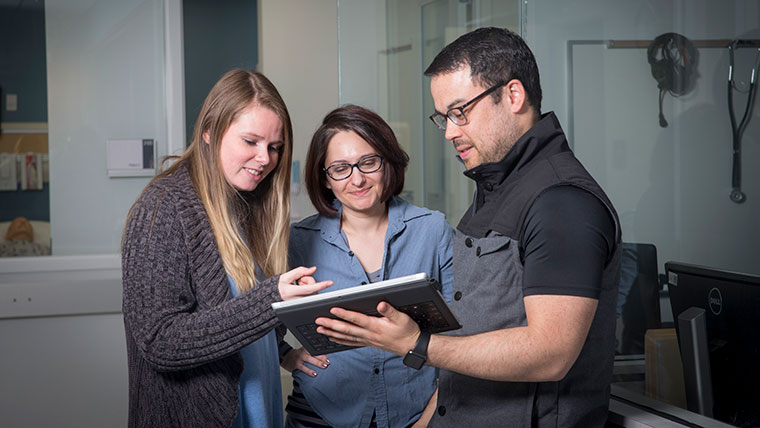 Doctor of Nursing Practice students use a tablet computer to log information at O'Reilly Clinical Health Sciences Center.