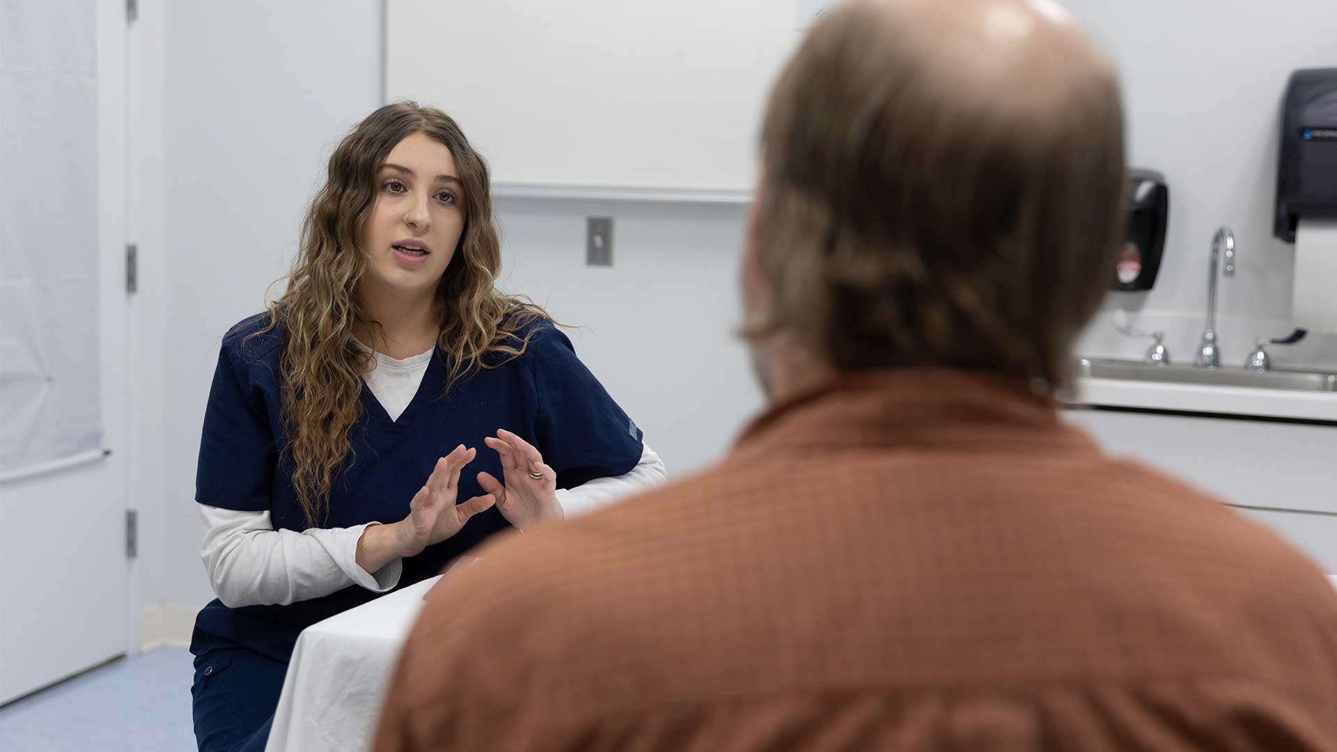 A nurse talks to a patient at the MSU Care facility.