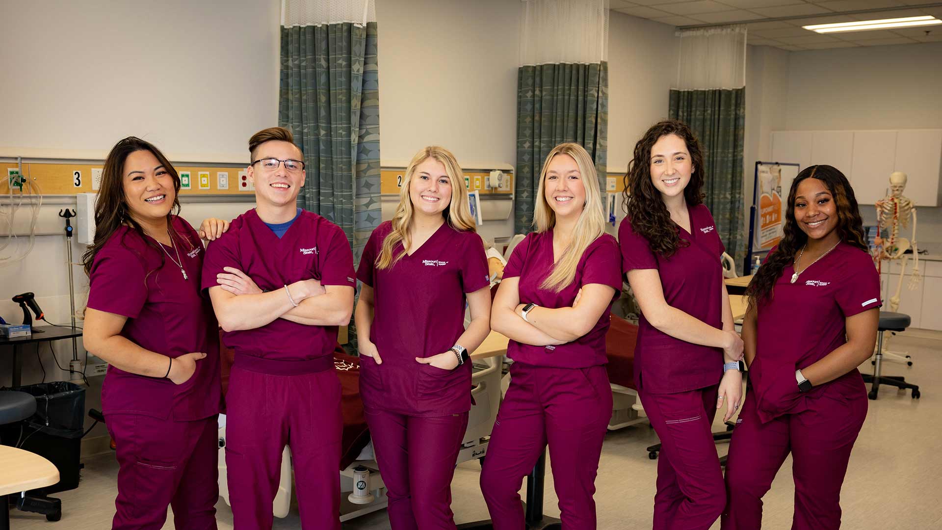 A group of Missouri State nursing students in maroon scrubs.