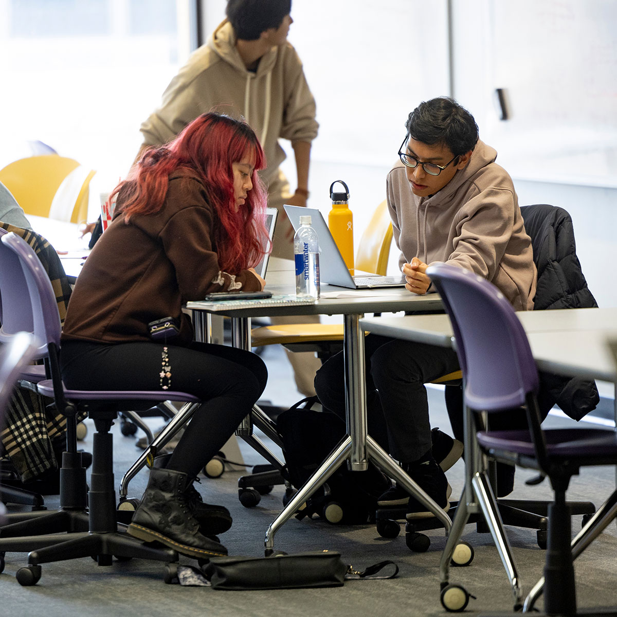 Two students study their notes in the Bear CLAW.