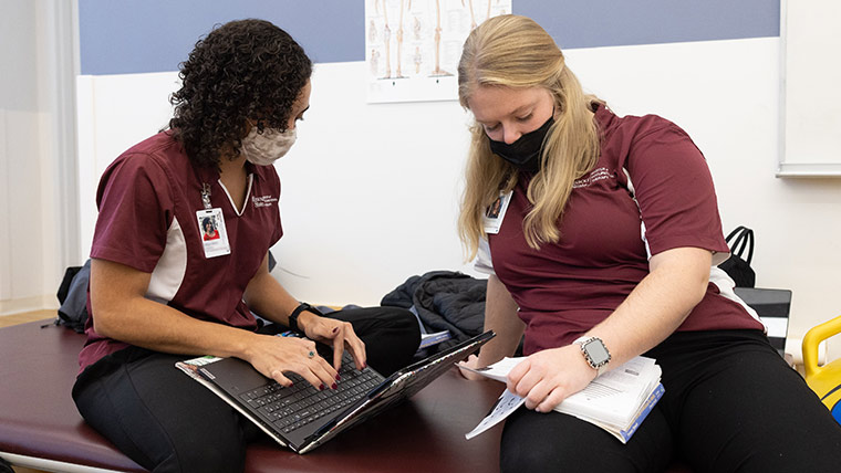 Two occupational therapy students studying together during class.