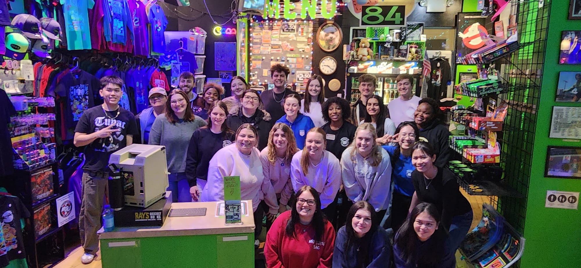 Students at an arcade posing for a picture