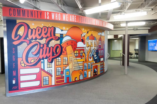 Colorful mural with a message. Community is who we are. Forward is where we are going.