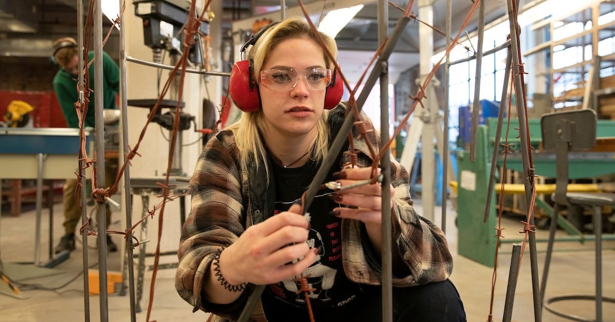 Female student works with metal in Brick City