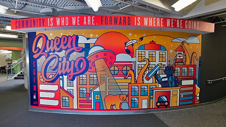 Colorful mural with a message. Community is who we are. Forward is where we are going.