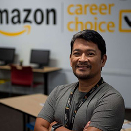 Smiling Amazon associate in a classroom. 