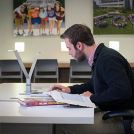 A student sitting at a desk studying. 