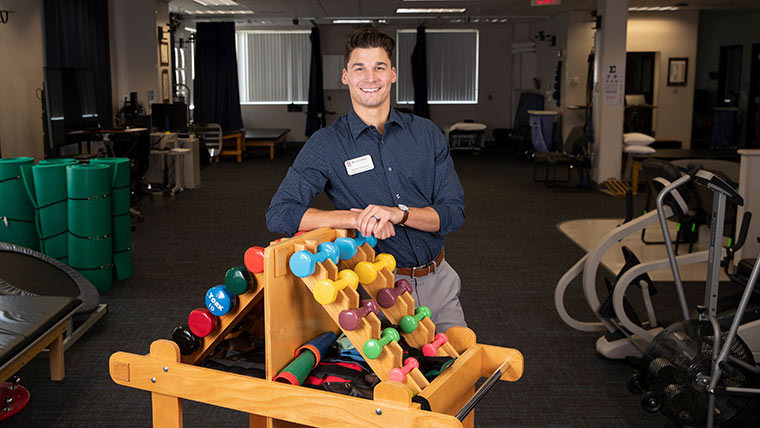 Physical therapy student posing in the Physical Therapy Clinic.