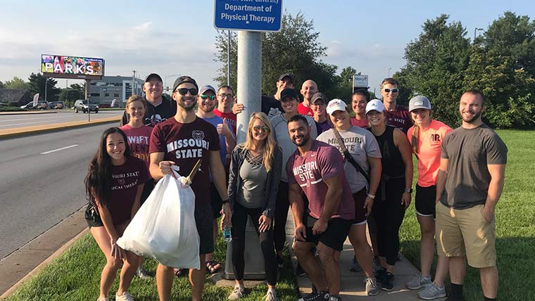 A group of physical therapy students picked up trash along the road for a community project.