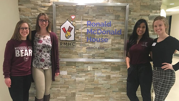 Four Missouri State physical therapy students at a community service event for Ronald McDonald House Charities of the Ozarks.