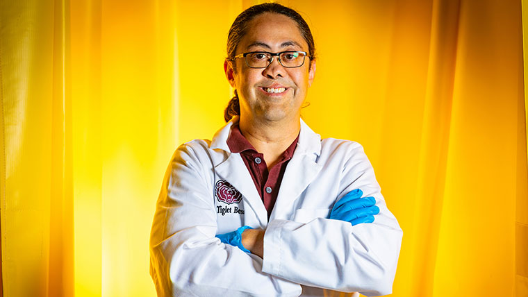 Portrait of Dr. Tiglet Besara, associate professor in Missouri State's physics, astronomy and materials science department, in his lab coat.