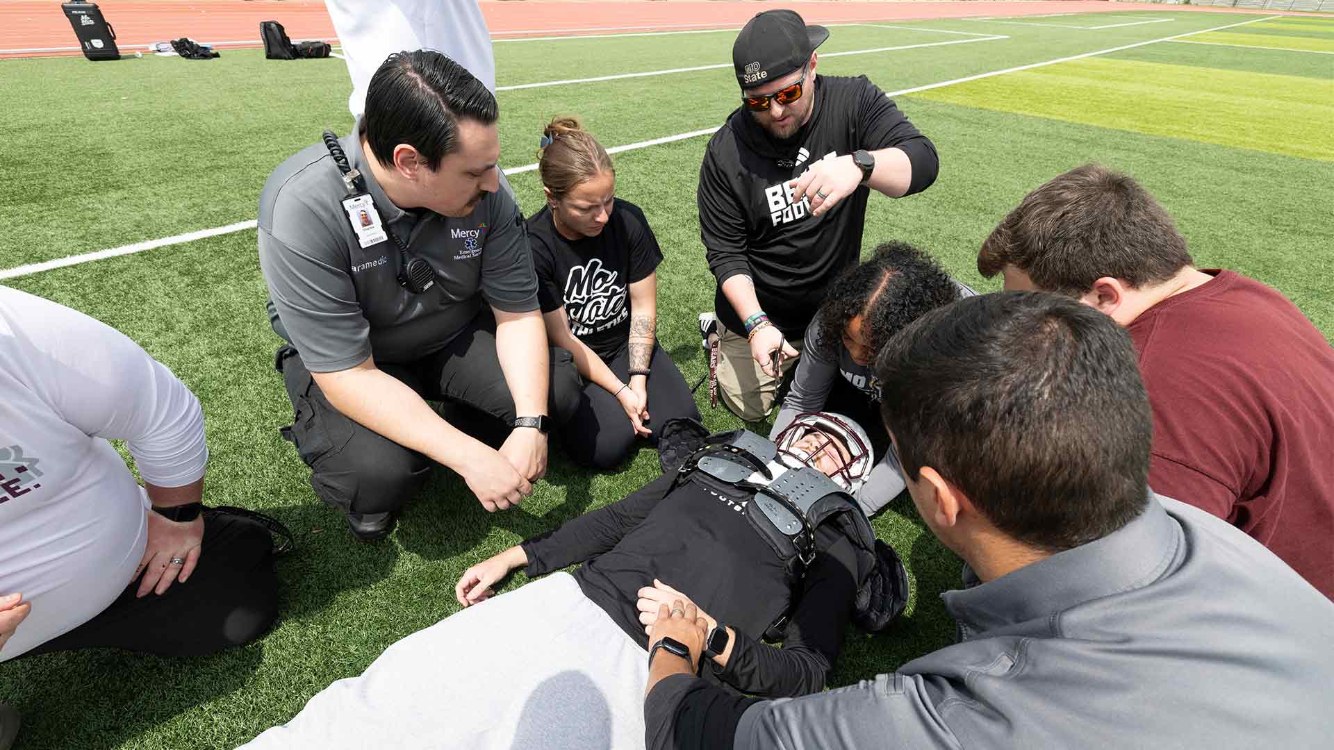 Missouri State team doctors and trainers working on football safety situations.