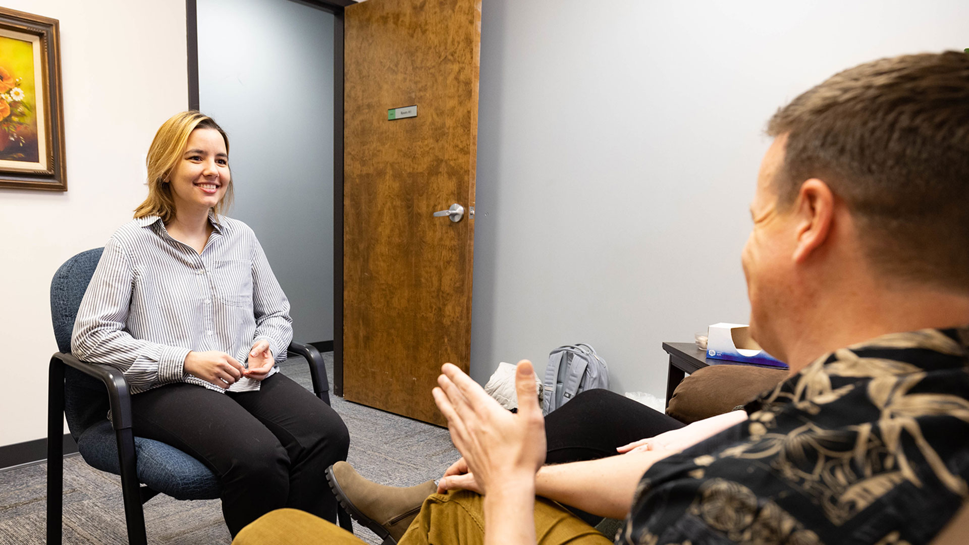 A student leads a counseling session as she attentively listens to her clients.