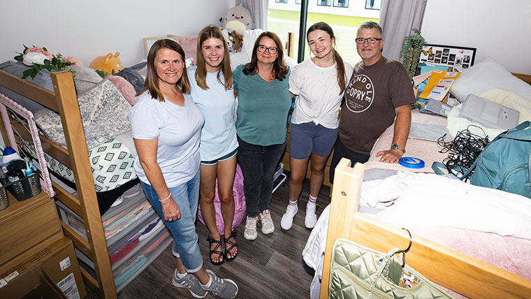 Missouri State students and parents taking a break, in a dorm room, on move in day. 