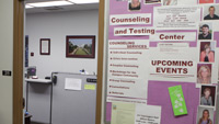 View of Counseling and Testing Center bulletin board next to an open doorway into an office