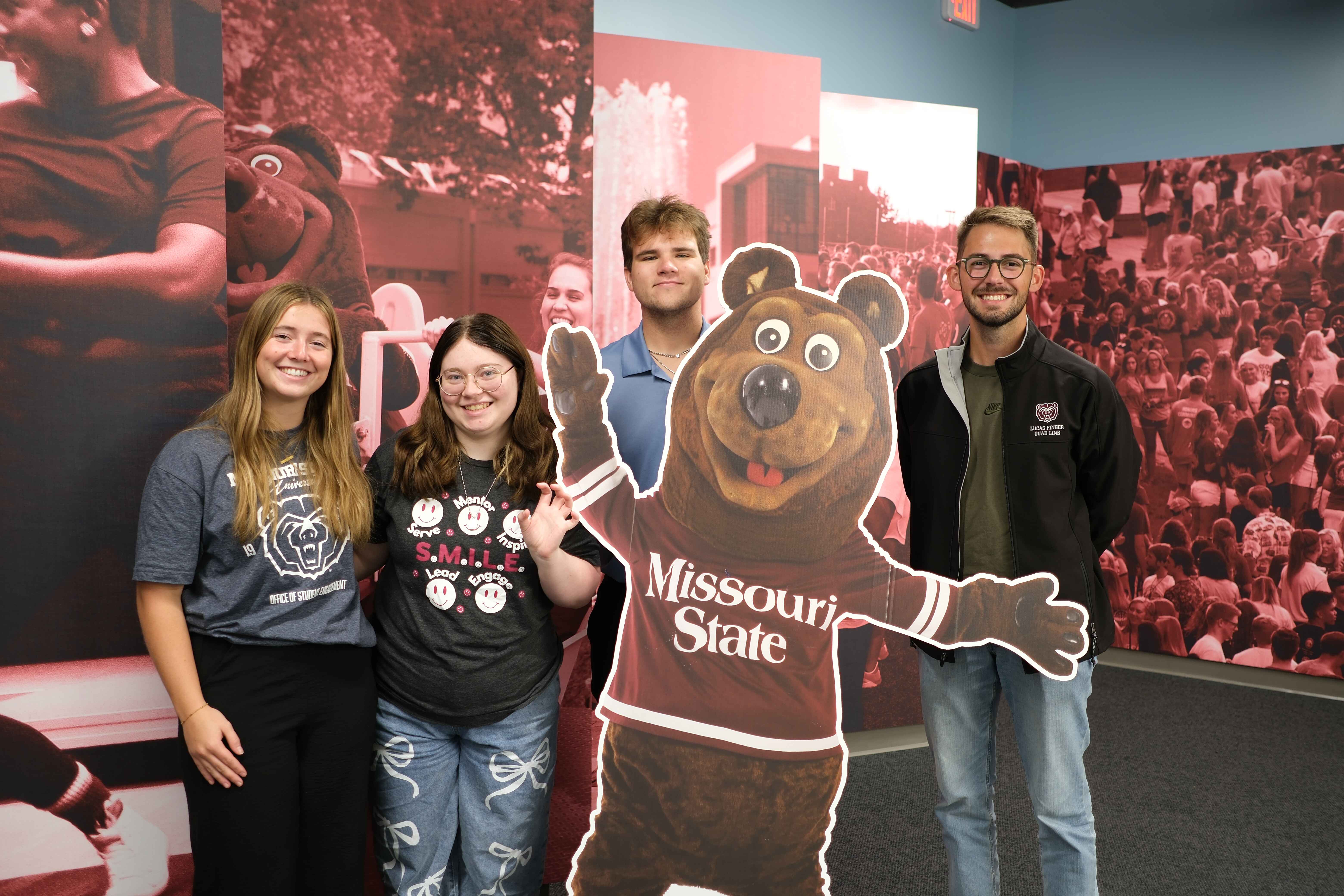 Students standing around boomer in Office of Student Engagement