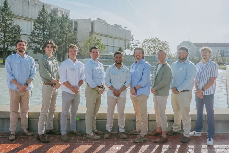 Interfraternity Council executive board members standing infront of the Hammons Fountain.