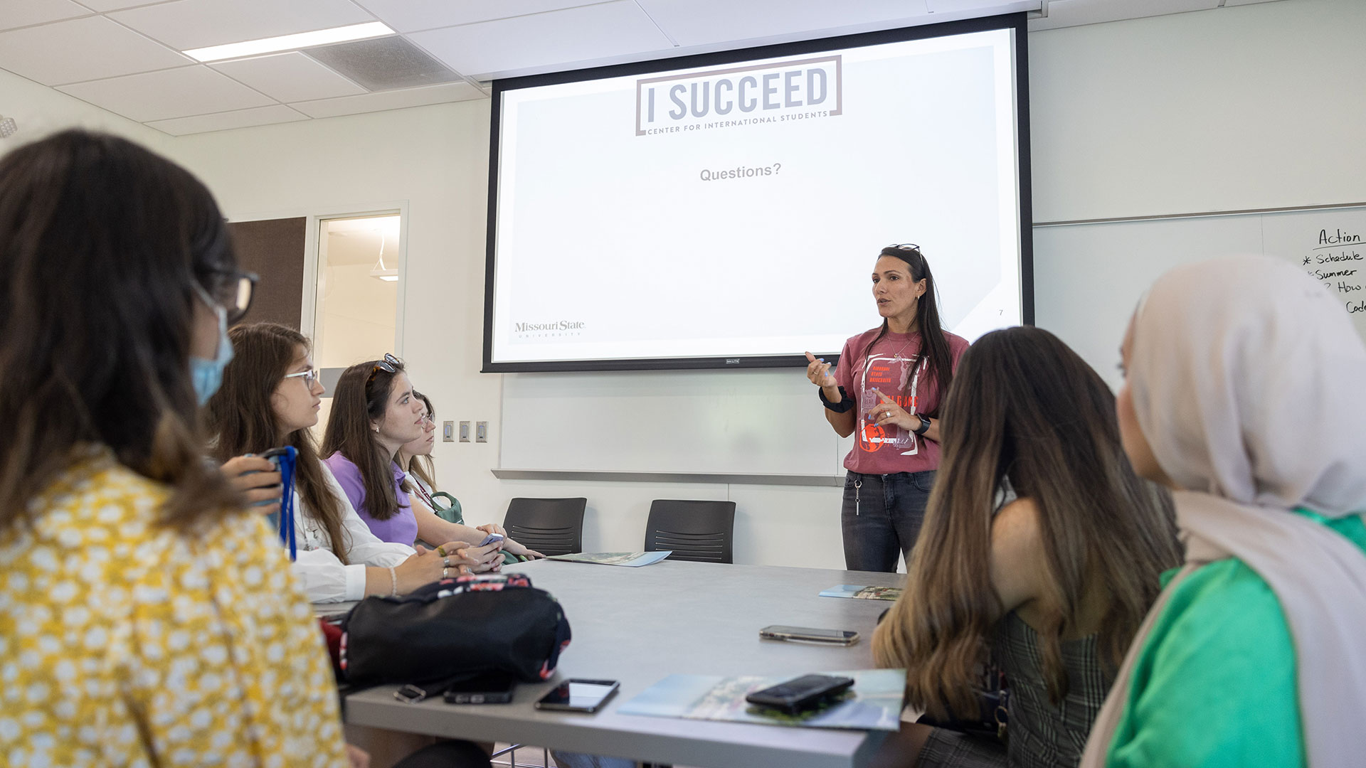 International students listen to a presenter speaking about I Succeed (the Center for International Students) during orientation.