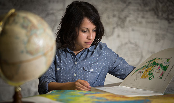 Nicole Noonan, an honors college student, studies an atlas.