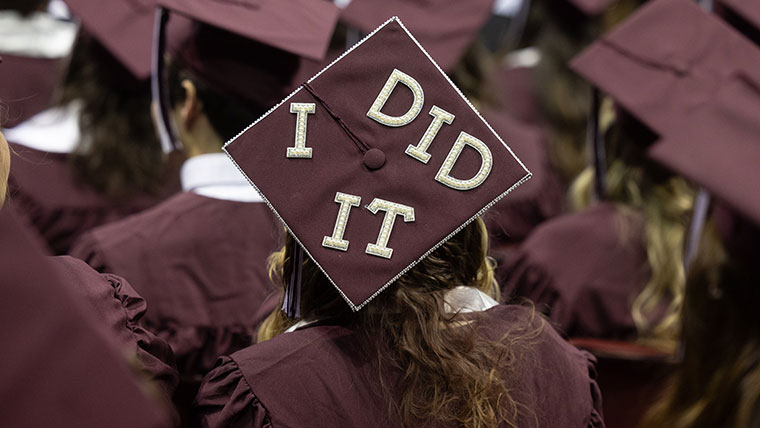 A graduating student's cap reads "I did it."
